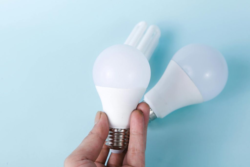 Two LED light bulbs on a blue background, highlighting energy efficiency.